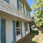 Siding dirty with mold, algae before soft washing in Charlotte, NC.