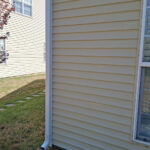 Clean house siding after pressure washing in Charlotte