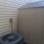 pristinely clean siding and shed at a Matthews, NC property after soft washing