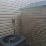 very dirty siding and shed at a Mathews, NC property before soft washing
